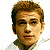Pixelated image of a person with light brown hair and fair skin, wearing a white shirt against a split background.