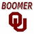 Two red 'OU' logos flank bold text reading 'BOOMER SOONER!!!', with a pixelated football player image below showing 'GO SOONERS!!!' on a black banner.