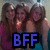 Three people with long brown hair stand closely together in a group pose, wearing dark and light-colored tops against a blurred background. The text "BFF" appears prominently at the bottom in blue pixelated letters on black.