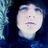 Pixelated image of a person with dark hair and blue clothing, next to text reading "Alex Evans" and "LOVES me" on black background.