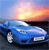 A blue convertible car is positioned on a dark surface with a sunset sky in the background, featuring orange and yellow hues blending into blue.