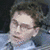 A pixelated image of a person in two stacked with red text and symbols on the right side