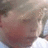 Pixelated close-up of a person's face with blurred background, showing partial facial features and indistinct colors.