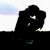 Silhouette of a figure in dynamic pose with white eyes, blue accents on base, against light background with faint clouds.