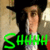 Pixelated image of a person with light brown hair wearing dark clothing, green text overlay reading 'SHHH' at the bottom.