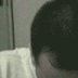 monochrome facial expressions with a small orange guitar-shaped object moving across the top