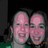 Two pixelated faces with pinkish skin tones and dark eyes appear side-by-side against a dark background, one slightly larger than the other.