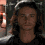 Four identical pixelated frames of a person with long brown hair wearing a dark shirt against a blurred background with light-colored elements.
