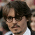 A static image of a person with dark brown hair, glasses, and a mustache wearing a white shirt and black jacket.