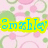 Pixelated image with yellow text reading 'Smiley' on a pink background with green and pink circular patterns.