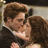 Two people in formal attire embrace closely, the male figure's head slightly tilted toward the female figure's face.