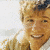 A 50x50 pixel animated contact sheet showing three frames of a person in a brown jacket and white shirt, with visible facial features and clothing details across sampled frames.