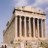 Pixelated image of a classical building with tall columns under a light blue sky.