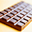Pixelated chocolate bar image with green background and text warning not to touch it, featuring a smiley face.