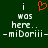Green background with white pixelated text reading "i was here.. -miDori iii-" on both sides and a red pixelated heart symbol above the left "i".