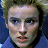 Static 48x48 pixel icon showing a close-up of a person's face with light brown hair, blue eyes, and pink lips against a dark background.