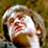 Static 48x48 pixel icon with low-resolution, pixelated depiction of a person's face and upper body against a blurred background.