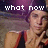 Pixelated image of a person with light skin and short hair wearing a dark shirt, standing against a purple background with white text reading 'what now' above.