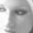 Grayscale pixelated image showing a partial face with visible eye and eyebrow, side profile, no text or additional elements.