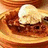 A pixelated image of a dessert with a scoop of ice cream on top, accompanied by red text on a black background.