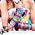 Pixelated static image of two figures in close embrace, one with light skin and dark hair holding another figure wearing a white top against a blurred background.