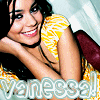 A pixelated image of a person with dark hair wearing a yellow and white striped top, resting their head on their arm with a smile.