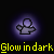Pixelated figure with rounded head and outstretched arms, glowing in dark background with yellow text below.