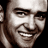 A 48x48 pixel buddy icon split into two sections: a grayscale close-up of a smiling person on the left and green text reading "Original Icons .com" on a dark green background on the right.