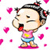 Pixelated cartoon character with black hair tied in red bows, wearing pink shirt with yellow detail and blue shorts, standing on pink base with pink hearts floating around.