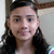 A person with long dark hair and earrings appears in three showing subtle facial expression changes
