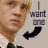 A pixelated image of a person with light hair wearing a white shirt and dark tie, next to text reading 'I want one' with a black arrow pointing left.
