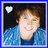 A pixelated portrait of a person with brown hair wearing a blue patterned jacket, featuring two variations: one with a white heart symbol and another with a pink heart symbol.
