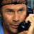 A 48x48 pixel buddy icon featuring a split composition with a person holding a phone on the left and red background text "STARSKY & HUTCH" above a white car on the right.