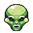 Pixelated green alien head with large black eyes, white pupils, and a wide open mouth showing teeth, set against a solid gray background.