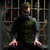 A pixelated character in a dark green vest and gray sleeves stands behind metal bars, with purple text overlay reading "Best Million Ever!" on the lower-left frame.