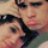 Two overlapping human faces with dark hair, light skin tones, and visible eyes in a pixelated static image.