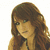 A woman with long brown hair and green eyes appears in three showing different poses and text overlays