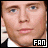 A 48x48 pixel buddy icon featuring a side-by-side contact sheet of two nearly identical frames showing the upper face and shoulders of a person with light skin, blue eyes, brown hair, wearing a white shirt under a dark jacket, with "FAN" text in black-and-white block letters on the left frame's bottom-right corner.