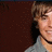 A pixelated image of a person with light brown hair and gray clothing, showing two states: one with text 'Yum.' on the left side and another without text.