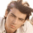 Pixelated close-up of a person's face with brown hair, closed eyes, and light skin tone against white background.