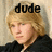 Pixelated image of a person with light brown hair wearing a dark shirt, with the word 'dude' in black block letters above the head against a beige background.