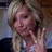 Pixelated image of a person with blonde hair making a peace sign, surrounded by bright pink text on white background.