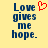 Yellow background with blue text reading "Love gives me hope." and a red pixelated heart symbol above the text.