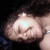 A person with dark hair and a light skin tone appears in three showing slight head movement against a dark background