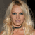 Static pixelated image of a person with long blonde hair wearing a dark choker necklace against a dark background.