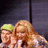 A pixelated animated icon shows two people in a group pose, one with green hair and the other with long blonde hair, both smiling against a dark background.