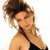 Static pixelated image of a woman with voluminous curly brown hair wearing a black halter top, cropped to show upper shoulders and neck against white background.