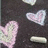 Pixelated image with pink and white heart shapes on dark background, text reading "Ian and Brittany 3-14-07" in blocky font.