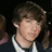 Pixelated image of a person with brown hair in dark clothing, split into four quadrants with cyan text overlays and solid gray background.