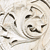 Pixelated static image of a light-colored animal face with dark eyes and nose, set against a light background with faint curved lines.